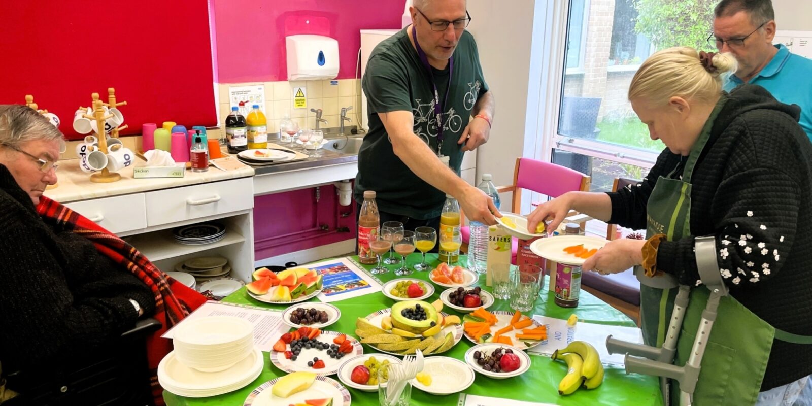 People selecting fruits to taste from mixed platters