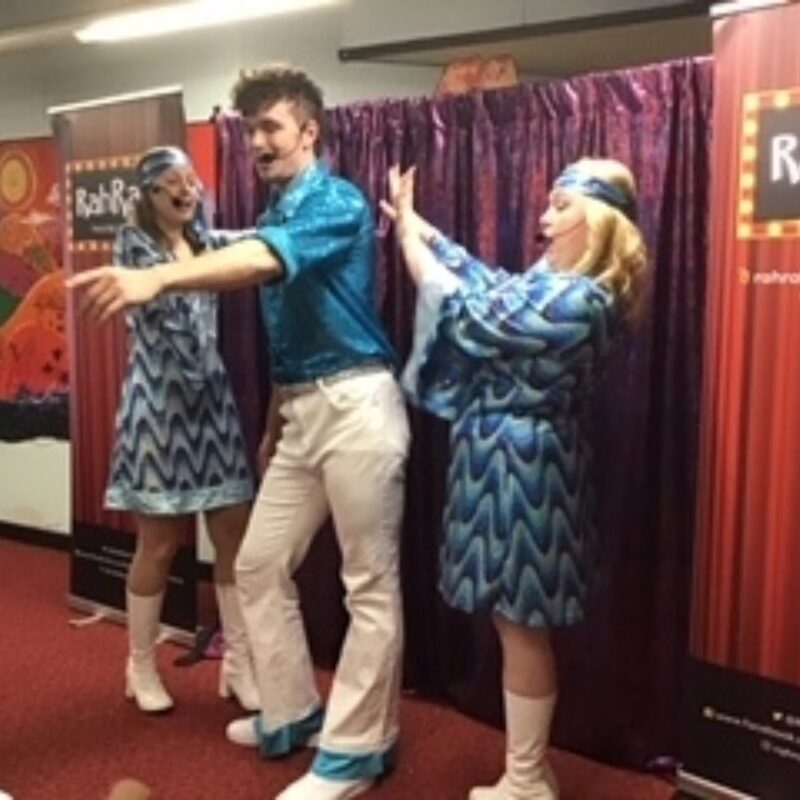 Performer in Abba costumes