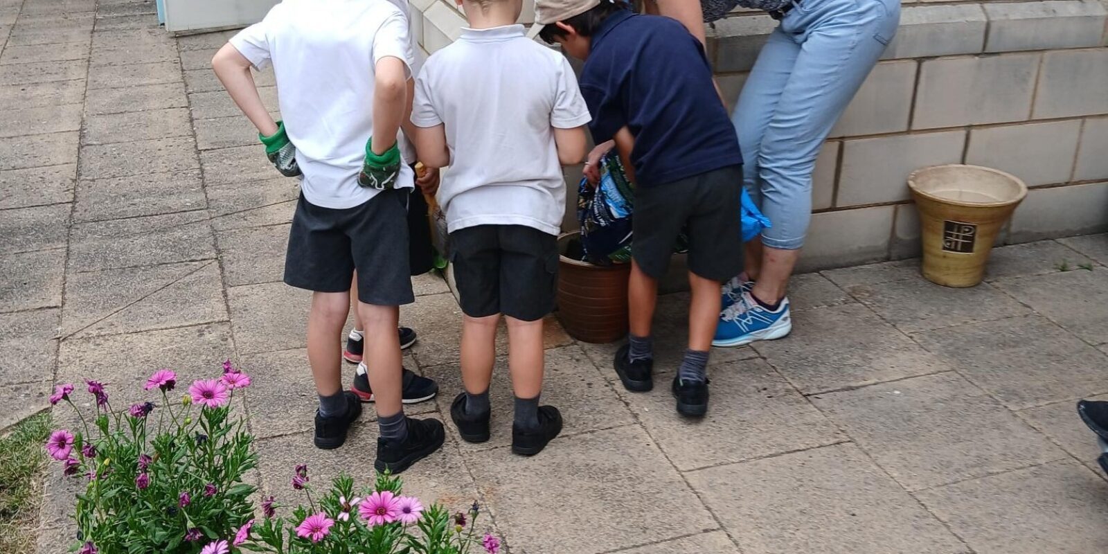 Group of children planing flower pots