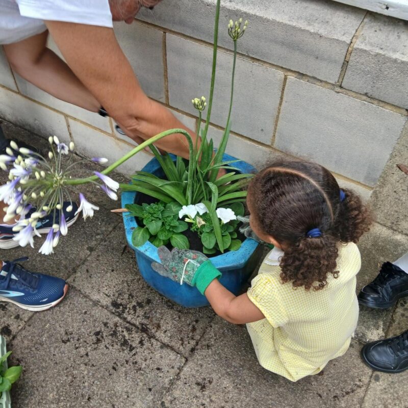Adult and child planting