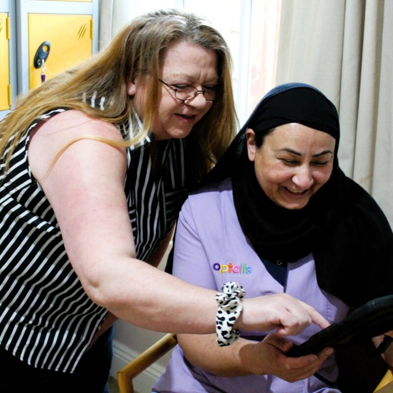 Team members looking at care records on a tablet