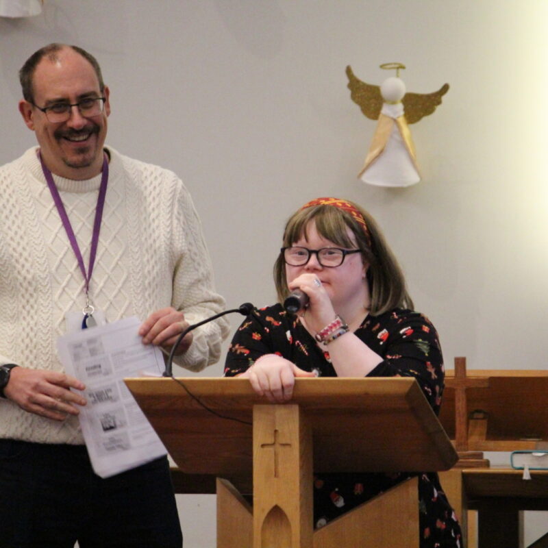Person doing a reading at carol concert